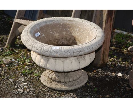 A planter with base, 13'' high x 19'' wide.