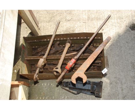 A steel box and contents including large Stilsons, spanners, car jack, wheel spanner, etc.