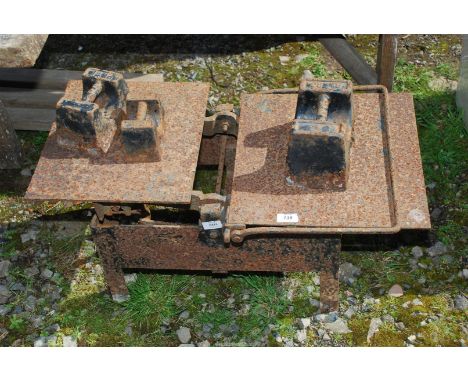 An old counter balance Scales with 7lb, 14lb and 28lb weights.