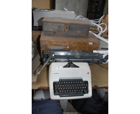 Two tool boxes and an Olympia typewriter.