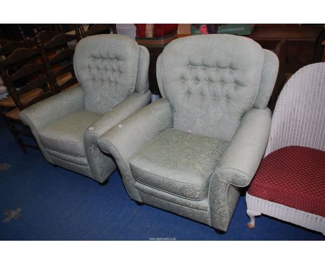 A pair of green button back easy chairs.