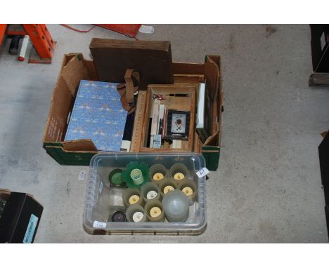 Two boxes of candles, photo album and tea light holders.