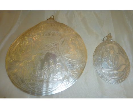 Lagre carved mother of pearl shell depicting religious scenes and similar smaller carved shell