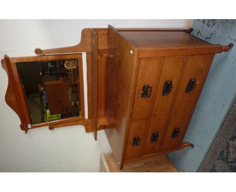 Light oak dressing chest with raised mirror back, 2 short above 2 long drawers
