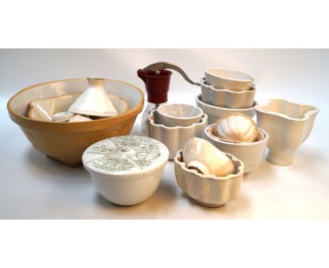 A large collection of ceramic kitchenalia early 20th CenturyComprising eleven jelly moulds, a quick-cooker by Grimwade's, two