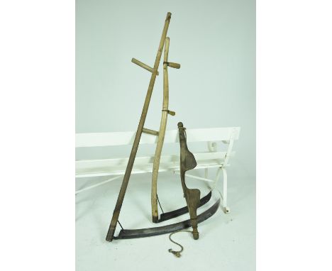 A pair of vintage hardwood scythes and a yokeEach scythe with a wooden shaft, two side handles and arch blade and the yoke of