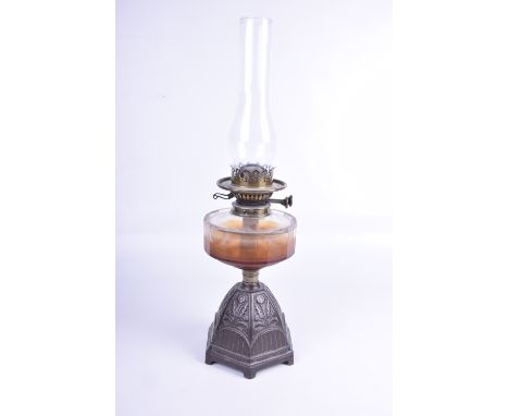 A cast iron and brass oil lamp, late 19th CenturyCast iron base with floral decoration, glass reservoir, complete with glass 