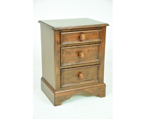A modern stained hardwood bedside chest of drawers by Willis and GambierThe rectangular moulded top above three graduated dra