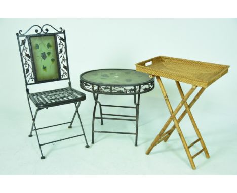 A modern painted iron patio set Comprising a folding chair with painted back panel and lattice work seat, a conforming painte