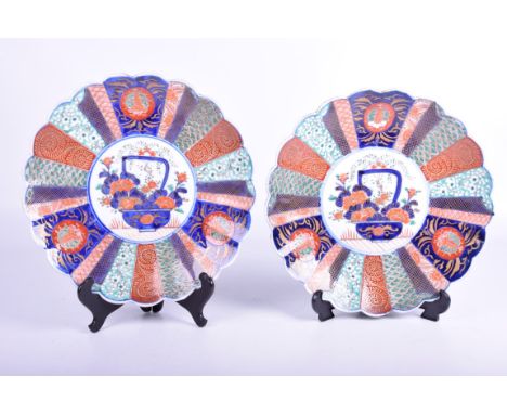 A pair of Japanese Imari chargers, Meiji period (1868 - 1912)Of circular form with scalloped rim, the central white glazed ro