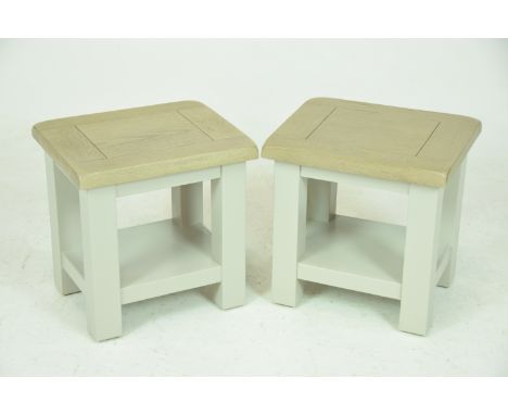 A pair of stained oak painted lamp tablesEach with a slab top raised on painted legs of square section, 40x40x33cms