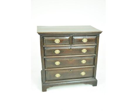 An 18th Century oak chest of drawersThe rectangular moulded plank top above two short and three long moulded drawers each wit