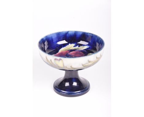 A William Moorcroft 'Pansy' pattern tazza, circa 1920The rounded deep dish with variegated blue to white ground, tubeline dec