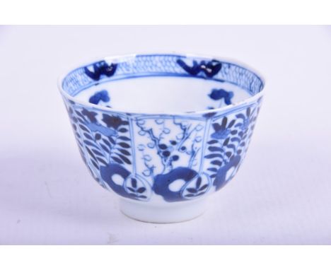 A Chinese blue and white porcelain teabowl, Kangxi period (1662 - 1722)The 'U' form bowl rising from a high footring, the ext