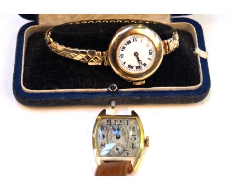 An 18ct gold Art Deco tonneau manual wind wristwatchA.f., to tan leather straps, together with a 9ct gold manual wind wristwa