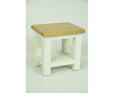 A modern light oak and painted lamp tableWith a slab top raised on legs of square section, 40x40x33cms