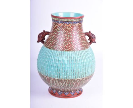 A Chinese pear shaped 'Bamboo' vase
The heavily potted body, flanked by twin qilin handles, the moulded turquoise glazed bamb