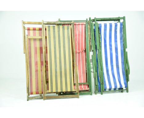 Six vintage folding wooden deck chairsEach with striped fabric seats, three with painted frames. 