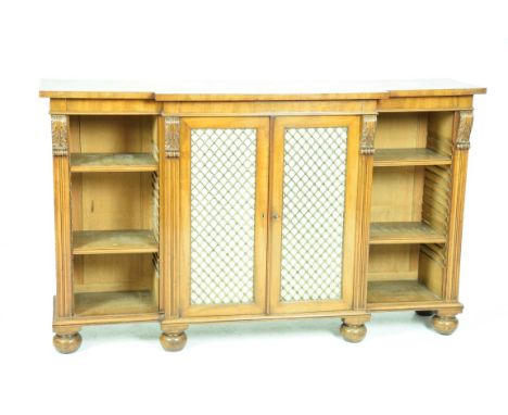 A Victorian mahogany breakfront mahogany bookcaseWith a plain frieze above a pair of gilt metal lattice work doors, flanked b