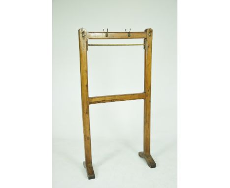 An early 20th Century pitch pine school coat railWith a "H" shaped structure and top rail each with canted corners raised on 