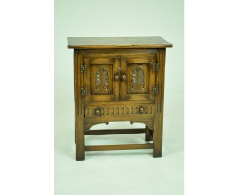 A 17th Century style oak side cabinet, 20th CenturyWith a rectangular moulded top above a channelled frieze and two doors eac