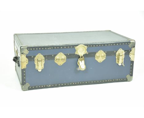 A Vintage Mossman travel trunkWith a  studded border, leather side handles and gilt metal clasp locks, 90x35x52cms.