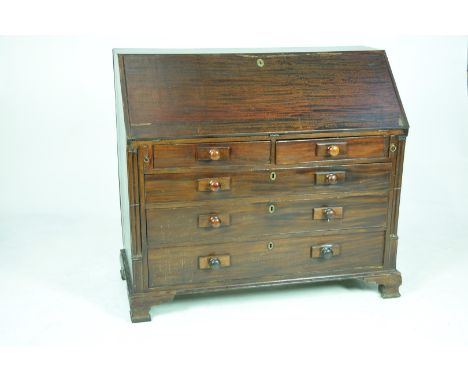 A Georgian mahogany bureau The fall front enclosing an inlaid and compartmentalised interior above an arrangement of two shor