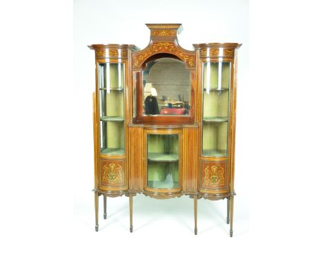 An impressive Edwardian Sheraton Revival inlaid mahogany display cabinetThe central turreted section with a cavetto cornice a