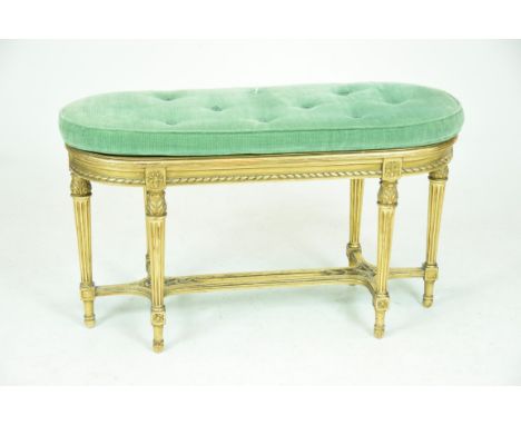 An early 20th Century French gilt wood oval window seatWith a rattan panel within a channelled frame above a rope effect frie