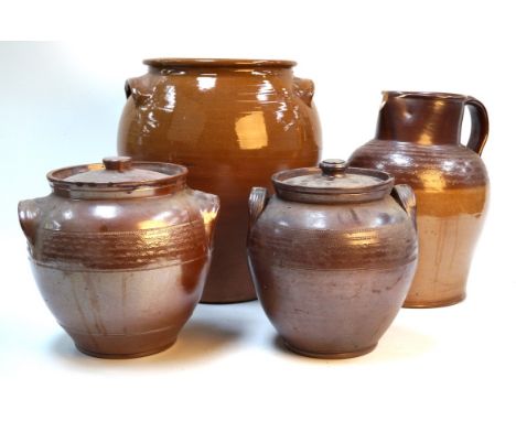 A collection of brown ceramic ware kitchen items early to mid 20th CenturyThe large example height 41cms, brown jug, two brow