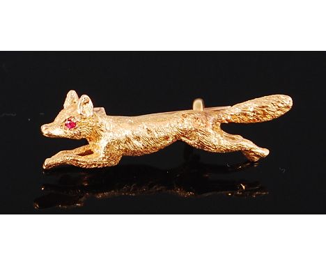 A gold brooch, modelled as a fox, having ruby set eye, unmarked but tests as 22ct, 4.3g, 3cm