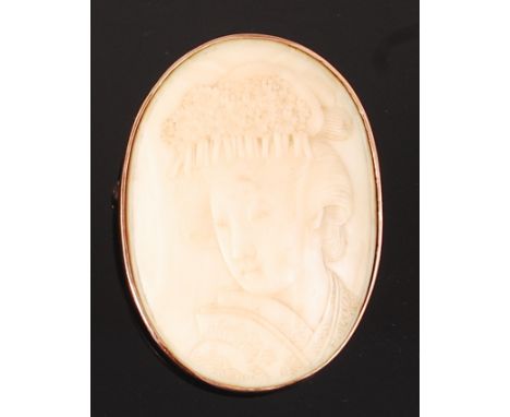 A Japanese Meiji period carved ivory brooch, depicting head and shoulders portrait of a geisha, 5 x 2.5cm, in 8ct gold Europe