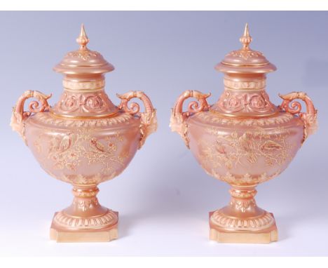 A pair of late 19th century Worcester porcelain pedestal vases and covers, each finely decorated in shot enamels with birds u