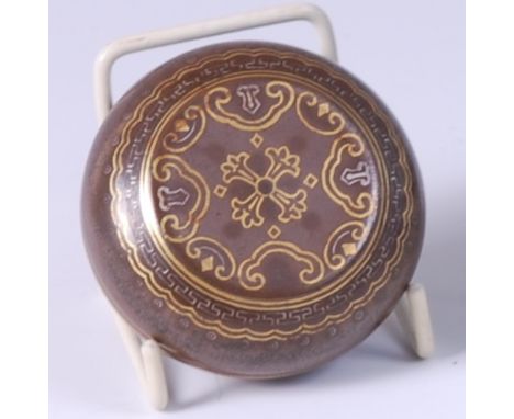 A Chinese brown glazed stoneware patch box and cover, with stylised gilt decoration and Qianlong mark verso, dia. 6.5cm   Con