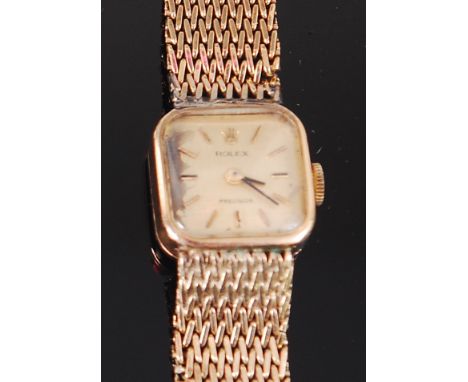 A ladies 9ct gold Rolex tank watch, having signed silvered dial with baton markers, manual wind jewelled movement, stamped Ro