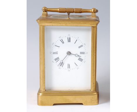 A circa 1900 French lacquered brass carriage clock, having visible platform lever escapement, white enamel dial with Roman an