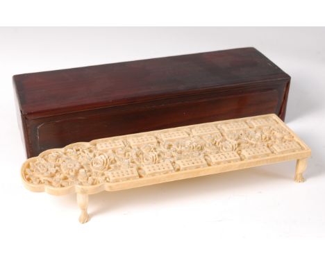 A circa 1900 Chinese carved ivory cribbage board, the whole carved in relief with flowers and foliage, the pegs in concealed 