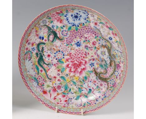 An early 20th century Chinese glazed stoneware footed bowl, in the famille rose palette, enamel decorated with dragons, with 