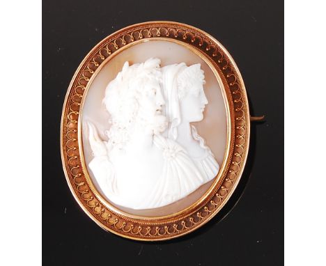 A 19th century continental carved shell cameo brooch, depicting Zeus and Hera double portrait, within a yellow metal surround