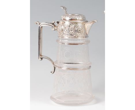 A Victorian glass and silver topped claret jug, of conical form, the hinged cover with presentation inscription over a frieze