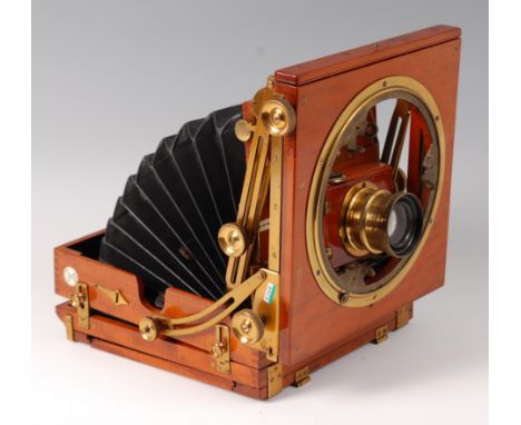 A circa 1900 Sanderson regular model plate camera, of mahogany construction with brass mounts and black leather bellows, bear