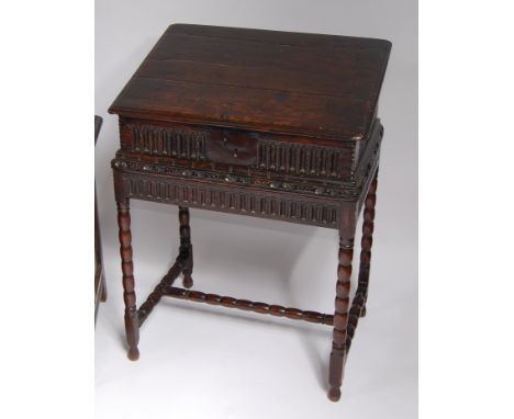 An antique joined oak Bible box, the hinged top opening to reveal later glazed and hinged interior, the whole on associated b