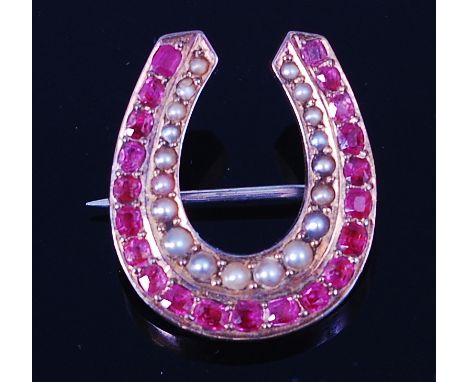 A late Victorian 14ct gold, seed pearl and ruby set brooch, in the form of a horseshoe, arranged as two rows of pavé set grad