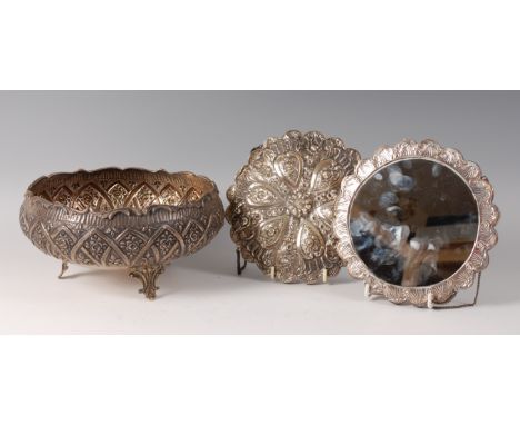 A late 19th century continental silver footed fruit bowl, embossed with reserves of leaves and flowers within arcaded reserve