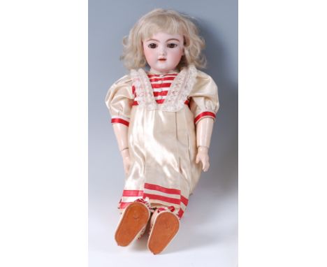 A Heinrich Handwerck / Simon & Halbig bisque headed and composition doll, having rolling brown eyes, painted features, and jo