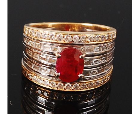 An 18ct yellow and white gold five band ring, the tapering band centre set with a four claw set oval cut ruby, ruby weight es