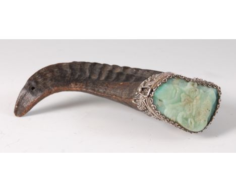 A rams horn snuff-mull, the hinged cover inset with a jade panel, carved in relief with a mask of Pan, the white metal mounts