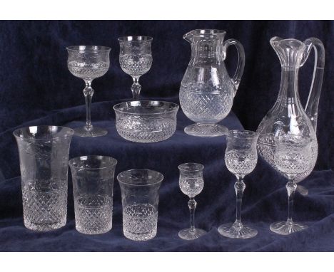 An Edwardian part suite of cut glassware, comprising; claret jug, two water jugs, twelve wine glasses, twelve hock glasses, t