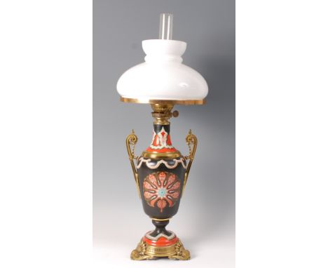 A Victorian stoneware gilt brass mounted pedestal oil lamp, having opaque glass shade, twin square cut applied scroll handles