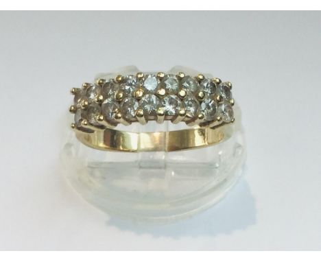 A 14ct yellow gold ring set with 18 x round white stones, ring weighs 4.5 grams, finger size P. 